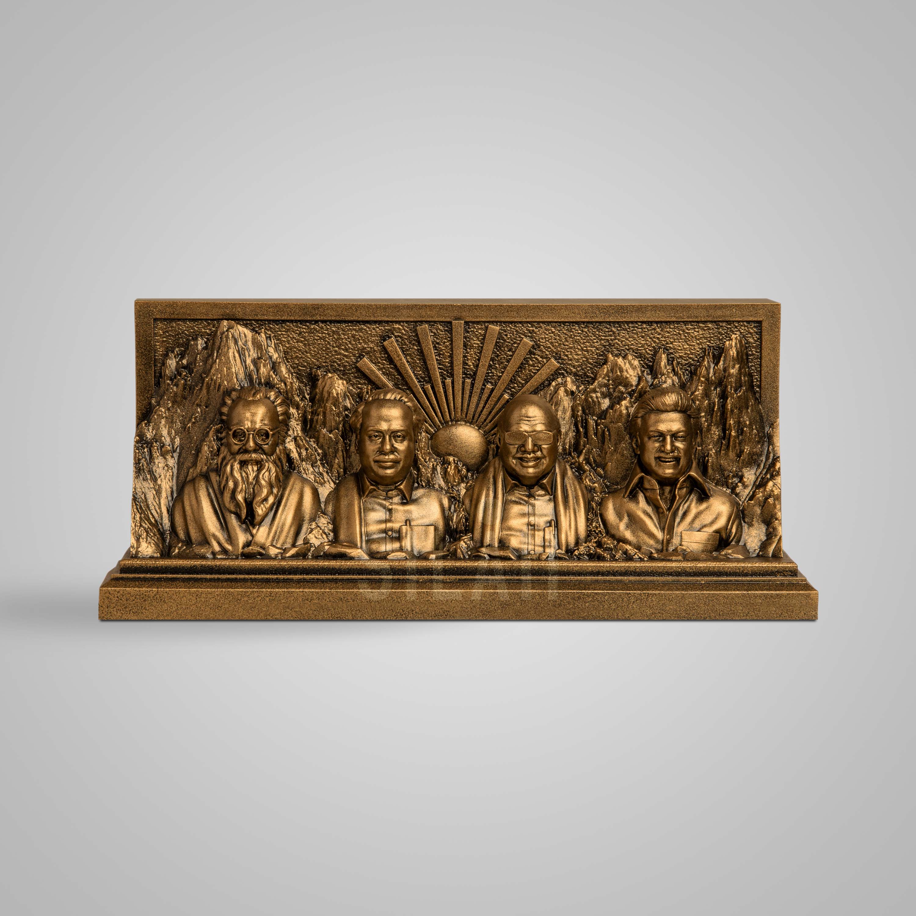 Bronze sculpture of Dravidian leaders with mountain background