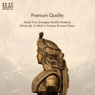 Golden bronze sculpture of Queen Velu Nachiyar with intricate traditional jewelry and attire, detailed craftsmanship